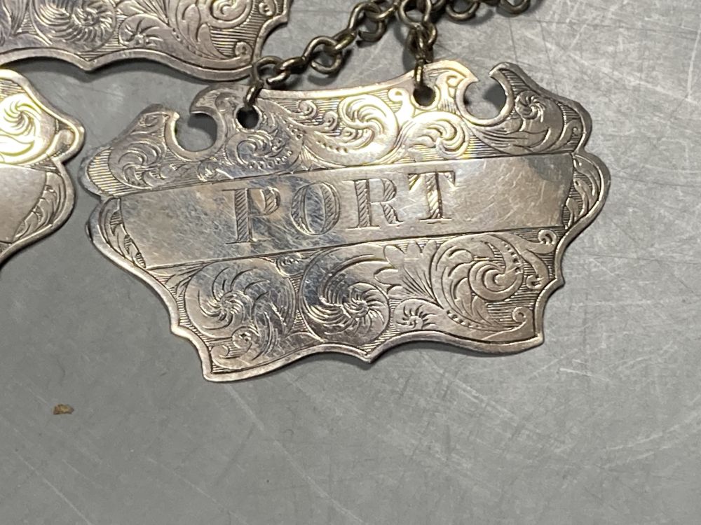 A matched set of three Victorian engraved provincial silver wine labels by William Rawlings Sobey,